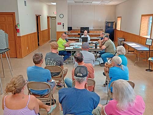 A contingent of Mirror View Drive residents got their wish from (l-r around the table) Pelican town supervisors James Cates and Walter Dahlquist Jr., chairman Nick Scholtes, clerk Mike Ring, and road supervisor/shop foreman Mike Carroll during last Monday’s meeting at Pelican Town Hall. (Photo by Ardith Carlton/River News)
