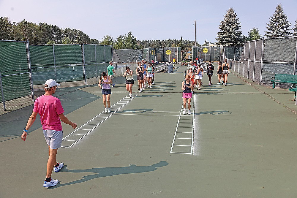 RHS girls’ tennis coach Matt Nichols watches as the team goes through footwork during the first day of practice at the RHS tennis courts Aug. 10. (Bob Mainhardt for the River News)