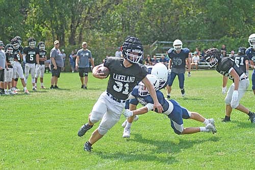 Logan Burrows runs with the ball during a scrimmage against Waupaca Friday, Aug. 14 at D.C. Everest Junior High School in Weston. Burrows led the Thunderbirds with 451 rushing yards last year. (Photo by Brett LaBore/Lakeland Times)