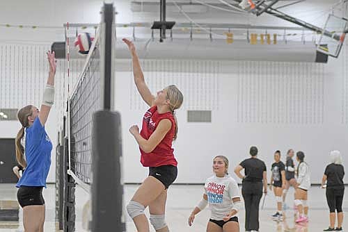 Vivian Pertile, right, spikes the ball with Allyson Seaberg on the block during sophomore through senior tryouts Monday, Aug. 17 at the Lakeland Union High School fieldhouse in Minocqua. (Photo by Brett LaBore/Lakeland Times)