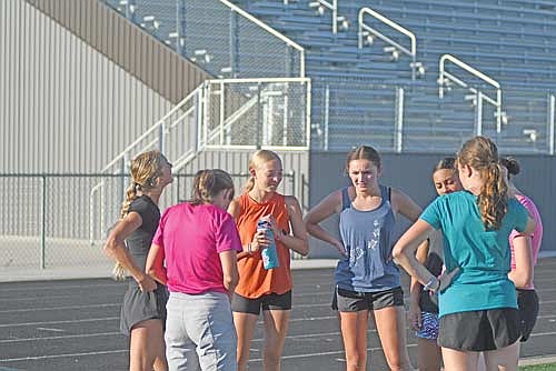 The Lakeland cross country girls’ team met up for the first practice of the season Monday, Aug. 17 at IncredibleBank Field in Minocqua. Team pictured, clockwise, are Rose Redman, Hailey Moore, Stella Eggen, Addison Eggen, coach Gordy Hartzheim, Emerson Rubo and Lydia Pritchard. (Photo by Brett LaBore/Lakeland Times)