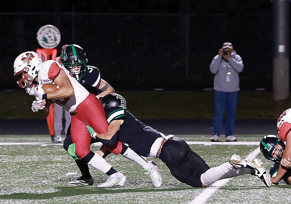 In this Oct. 10, 2025 file photo, Rhinelander’s Ryley Hull and Rowan Wiczek attempt to tackle Medford’s Carson Ingersoll during the first quarter of a GNC football game at Mike Webster Stadium. Medford has been picked as the favorite to win the conference this year, according to the annual GNC football media poll announced today. Rhinelander is picked to finish seventh in the eight-team league. (Bob Mainhardt for the River News)