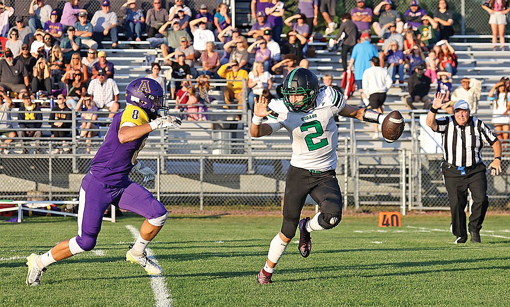 In this Aug, 22, 2025 file photo, Rhinelander’s Abe Gretzinger is pressured by Ashland’s Cody Brinker during a non-conference football game in Ashland. The Hodags and Oredockers will kick off the regular season in Ashland tonight for a second consecutive year, with Rhinelander’s looking to avenge a 26-20 overtime defeat a season ago. (Bob Mainhardt for the River News)