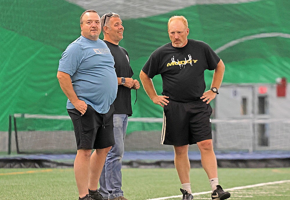 Assistant coaches Rodney Sternhagen, left, and Nathan Bates, center, stand next to head coach John Vojta during Rhinelander High School boys’ soccer practice in the Hodag Dome Monday, Aug. 17. Sternhagen, a former Rhinelander assistant, returns to the staff after most recently serving as head coach at Northland Pines. (Jeremy Mayo/River News)