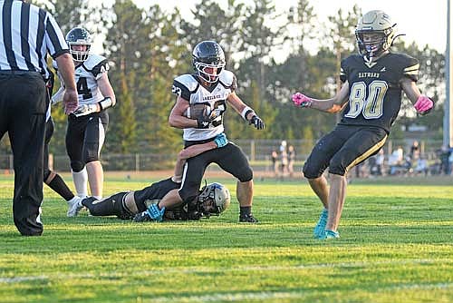 Logan Burrows rushes for a touchdown in the first quarter of the season opener against Hayward Friday, Aug. 21 at Rod Lundberg Field in Hayward. Burrows ran for a total of three touchdowns. (Photo by Brett LaBore/Lakeland Times)