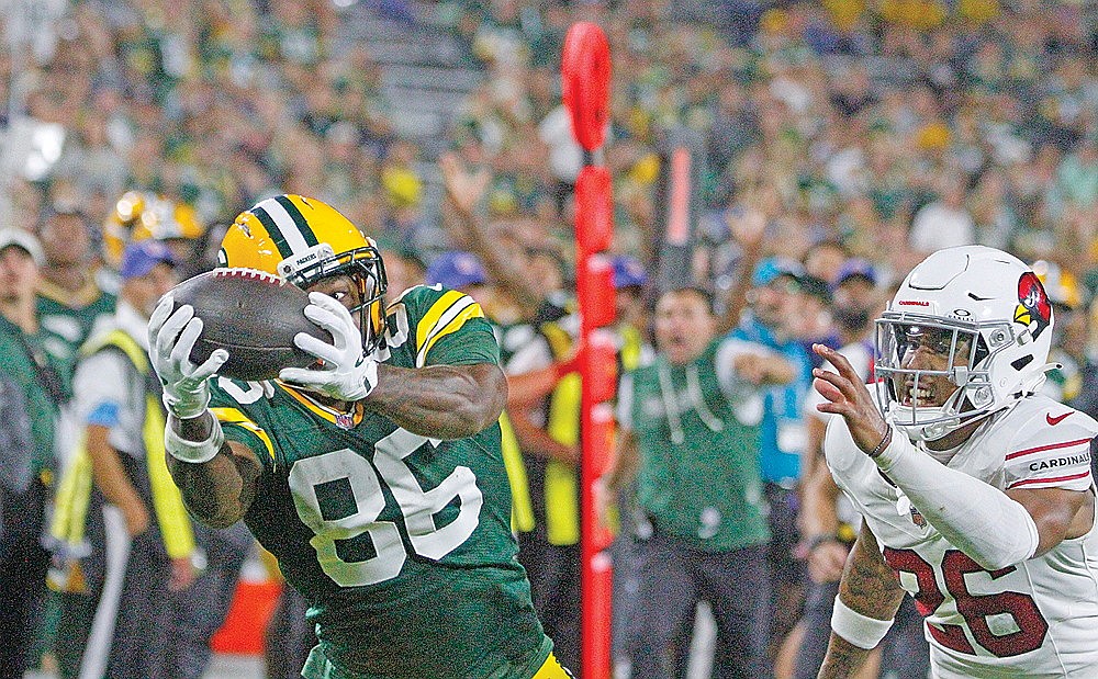 Green Bay wide receiver Kisean Johnson keeps his eye on the ball and hauls in a 28-yard touchdown pass from quarterback Kyle McCord at Lambeau Field Friday night. The Packers converted on the ensuing two-point conversion to pull to within three of the Arizona Cardinals late in the fourth quarter. The touchdown kickstarted Green Bay’s 15 straight points to end the game after trailing 38-27 with under five minutes to play.