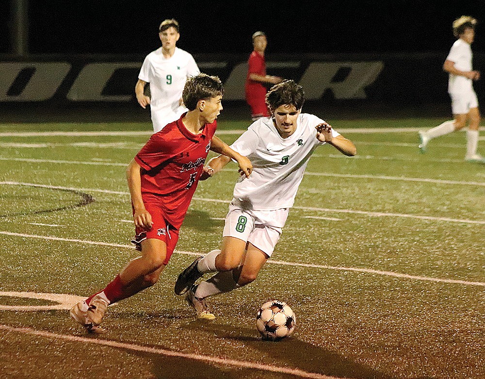 Rhinelander’s Owen Evers defends Medford’s Carter Ziehlke during the second half of a GNC boys’ soccer game in Medford Tuesday, Oct. 6. The Hodags defeated the Raiders, 4-3.