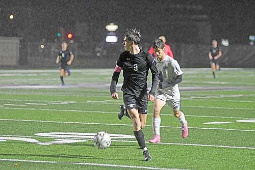 Lincoln Friedley looks at his options followed by Northland Pines’ Casey Congleton in the first half of a conference game Thursday, Oct. 15 at IncredibleBank Field in Minocqua. (Photo by Brett LaBore/Lakeland Times)