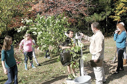 Middle school students working  to clean up their backyard