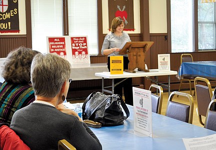 Speaker discusses worker injustice  during presentation at St. Augustine's