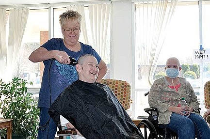 Local woman raises money, shaves head to support co-worker's daughter