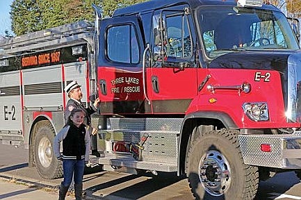 Three Lakes students ride fire truck to school