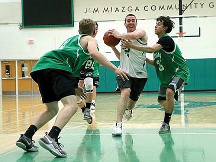 Staff dominates students in charity basketball game