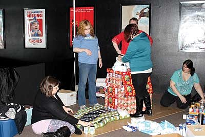 Teams stack cans for food pantry